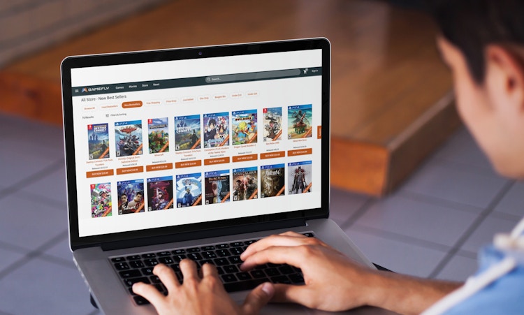 young boy looks at gamefly website on his laptop