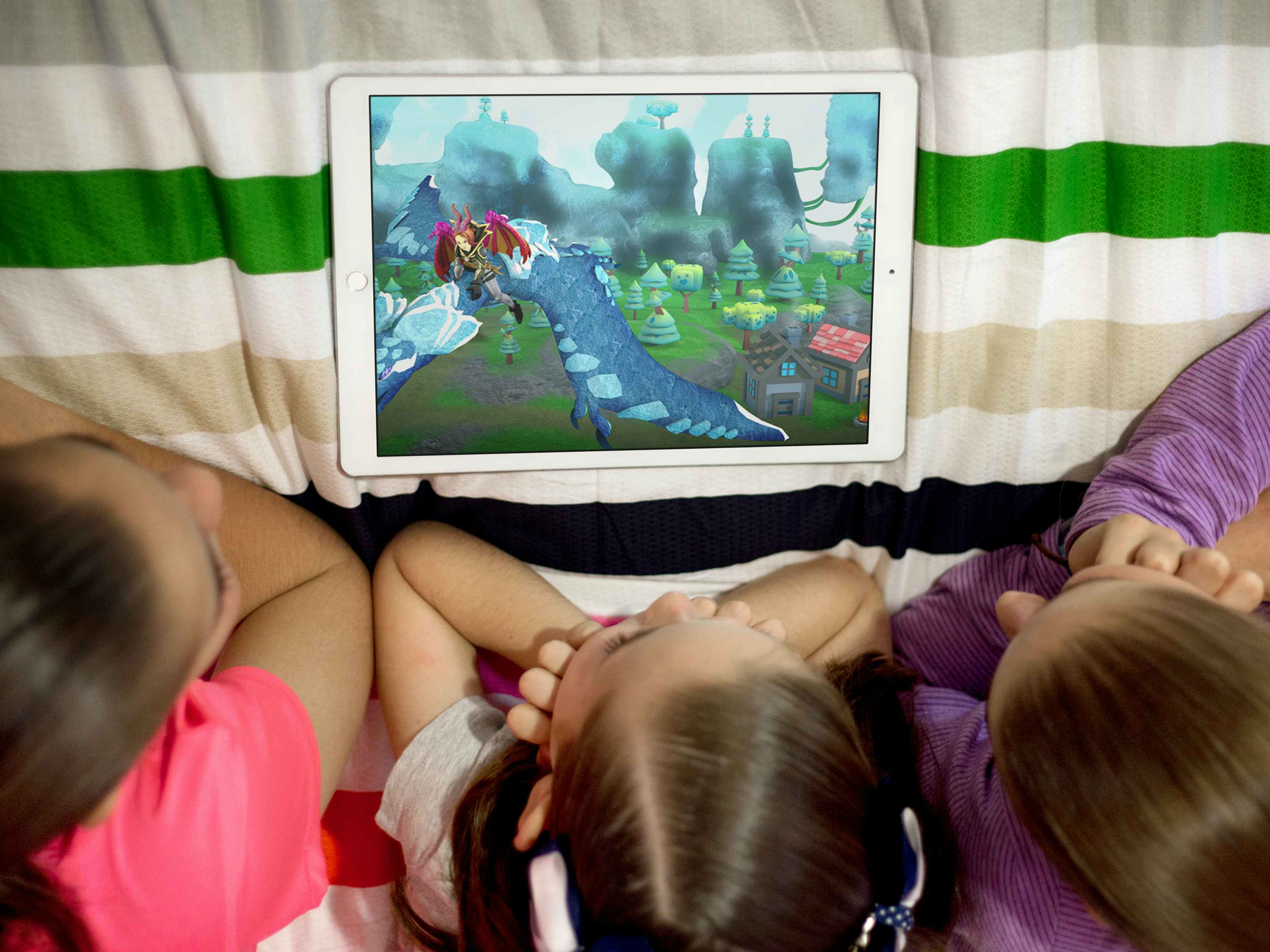 three girls look at roblox on a tablet