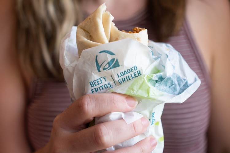 A person holding a taco bell burrito 
