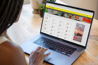 A woman looking at the krazy coupon lady coupon page.