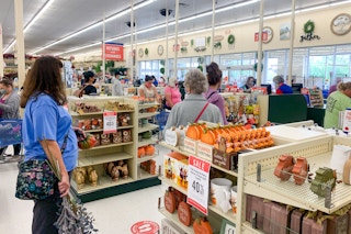 Customers wearing face masks, waiting in line at checkout, inside Hobby Lobby.
