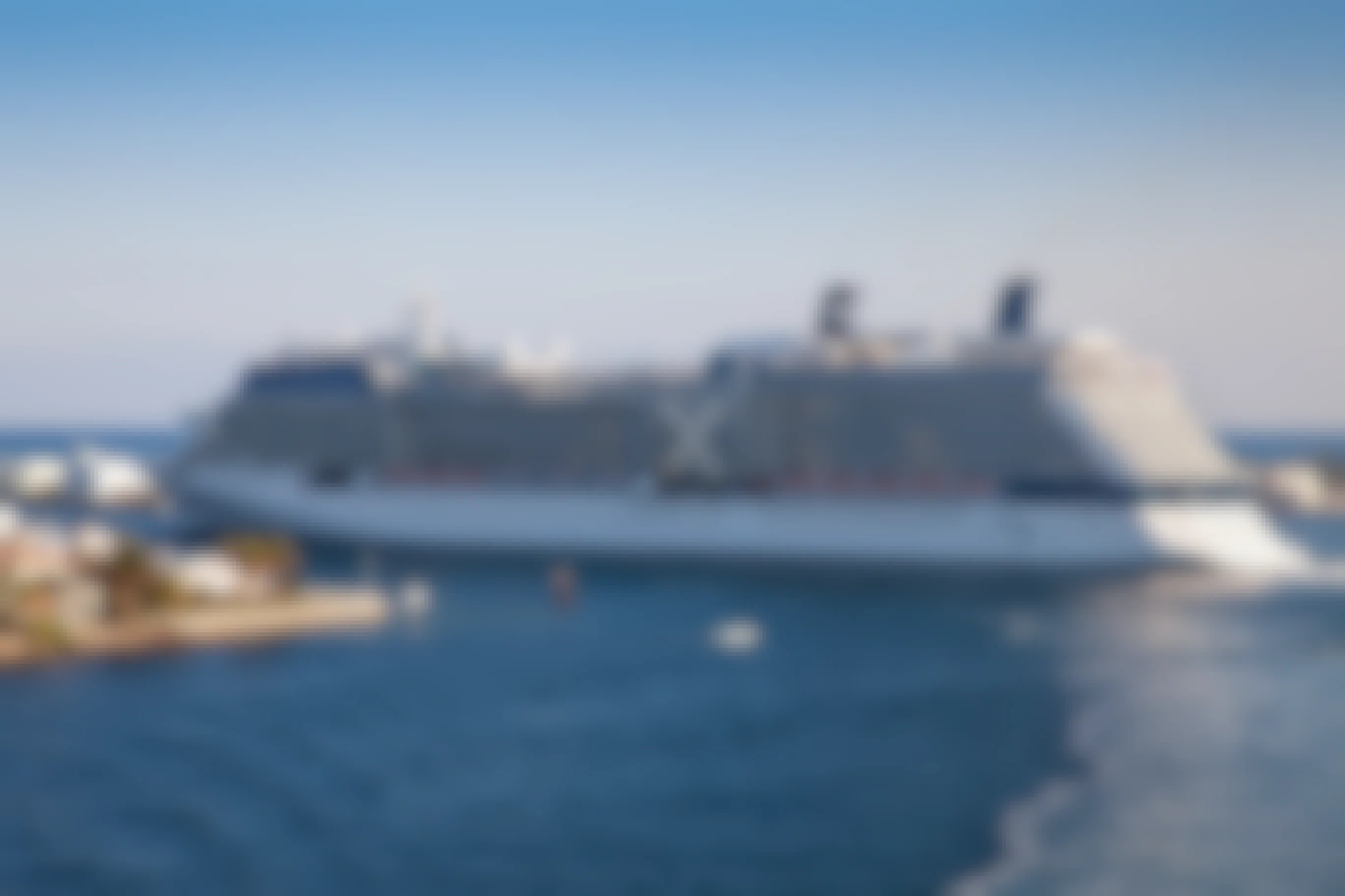The Celebrity Solstice cruise ship departing from a pier.