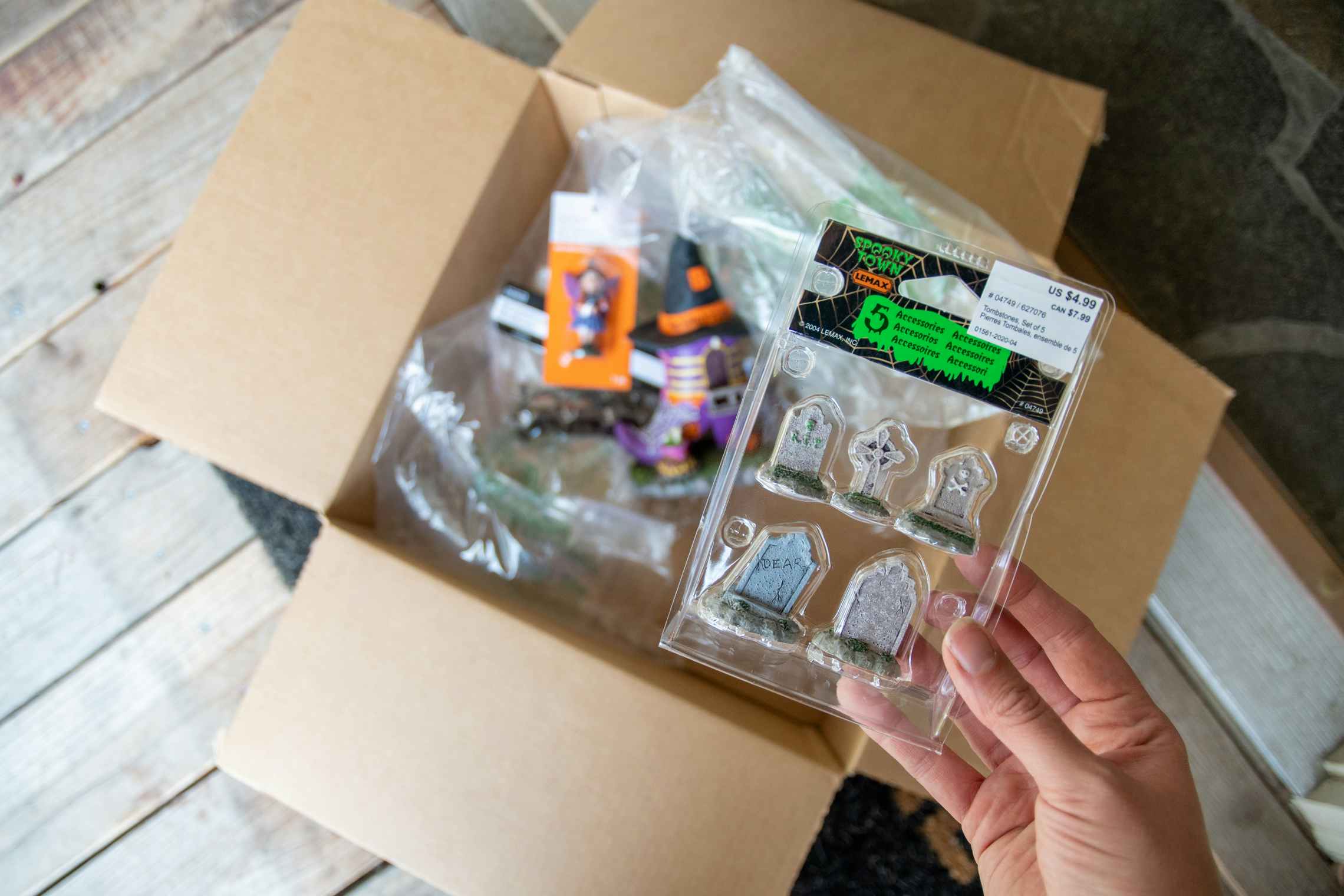 Box of halloween miniatures being unboxed at a front door step