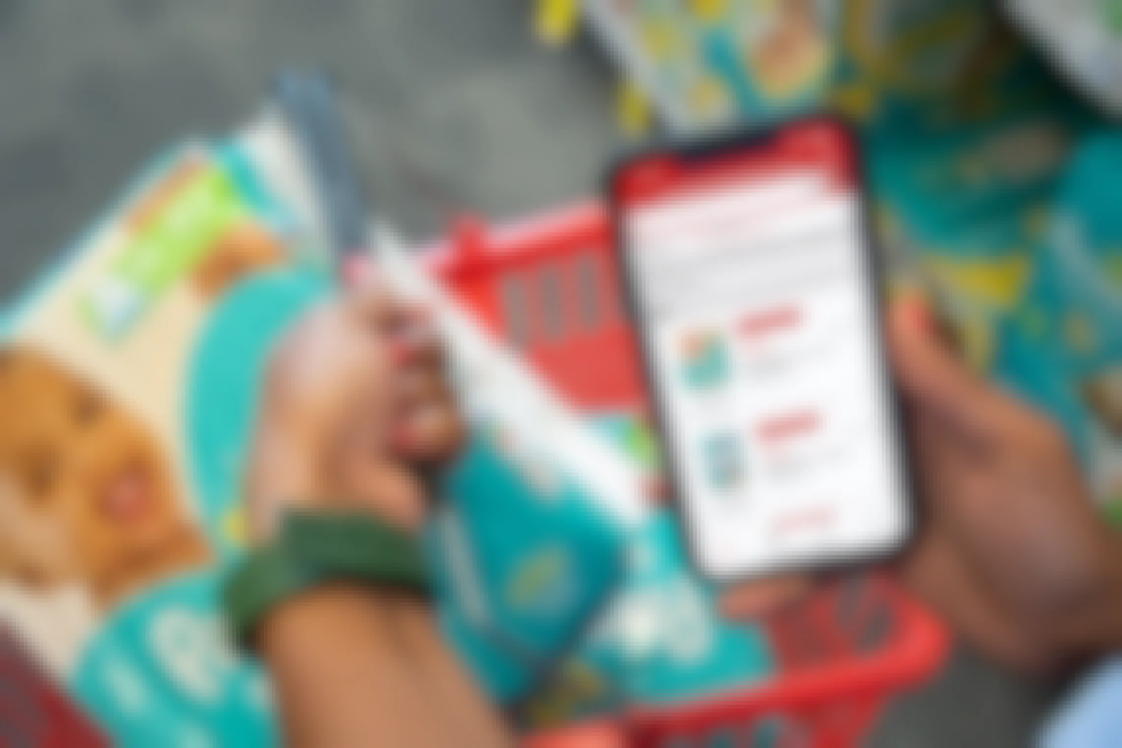 Pampers coupons on the CVS app with a basket holding two packs of pampers diapers.