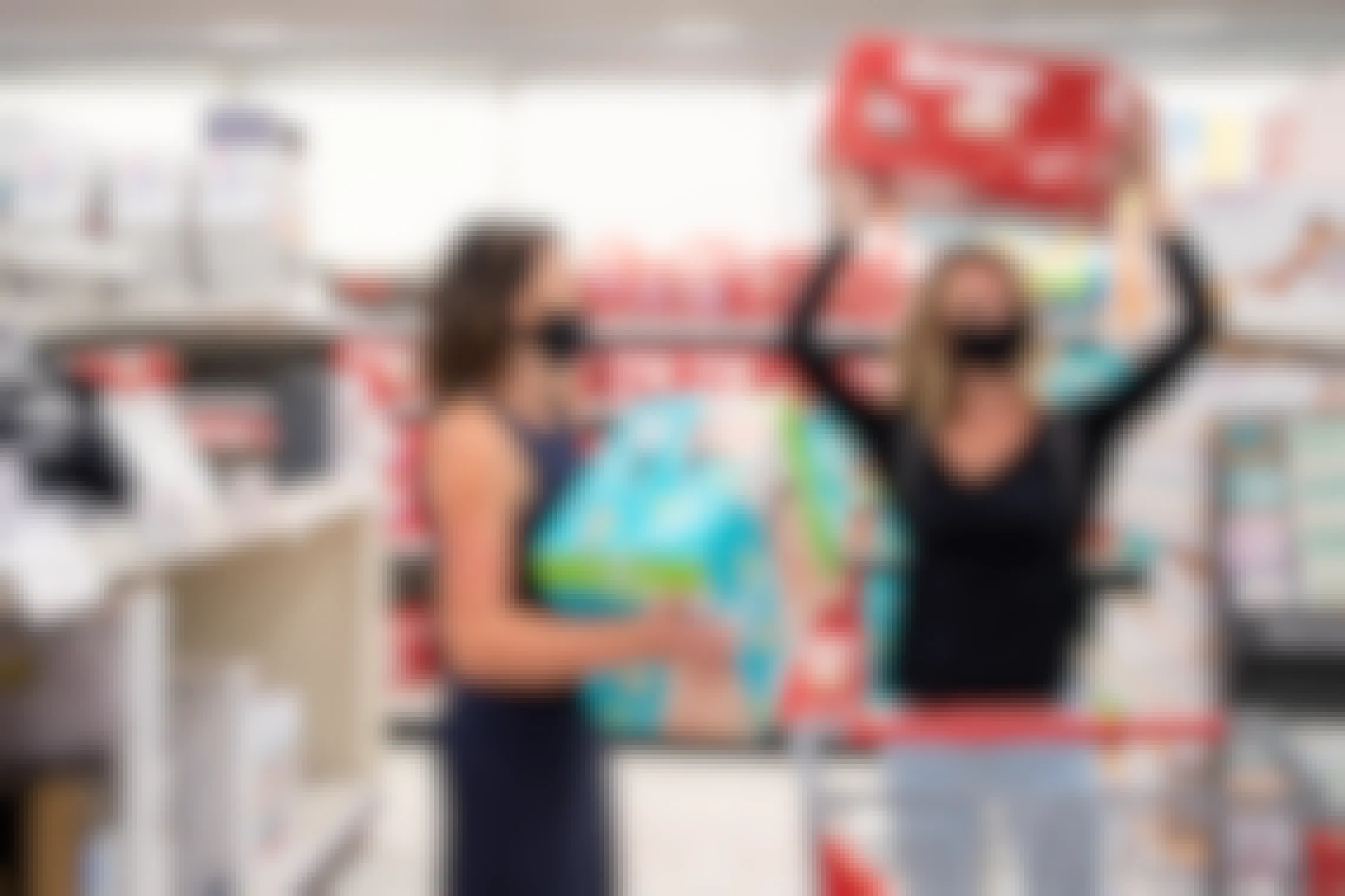 Two women shopping for pampers and Huggies diapers in Target.