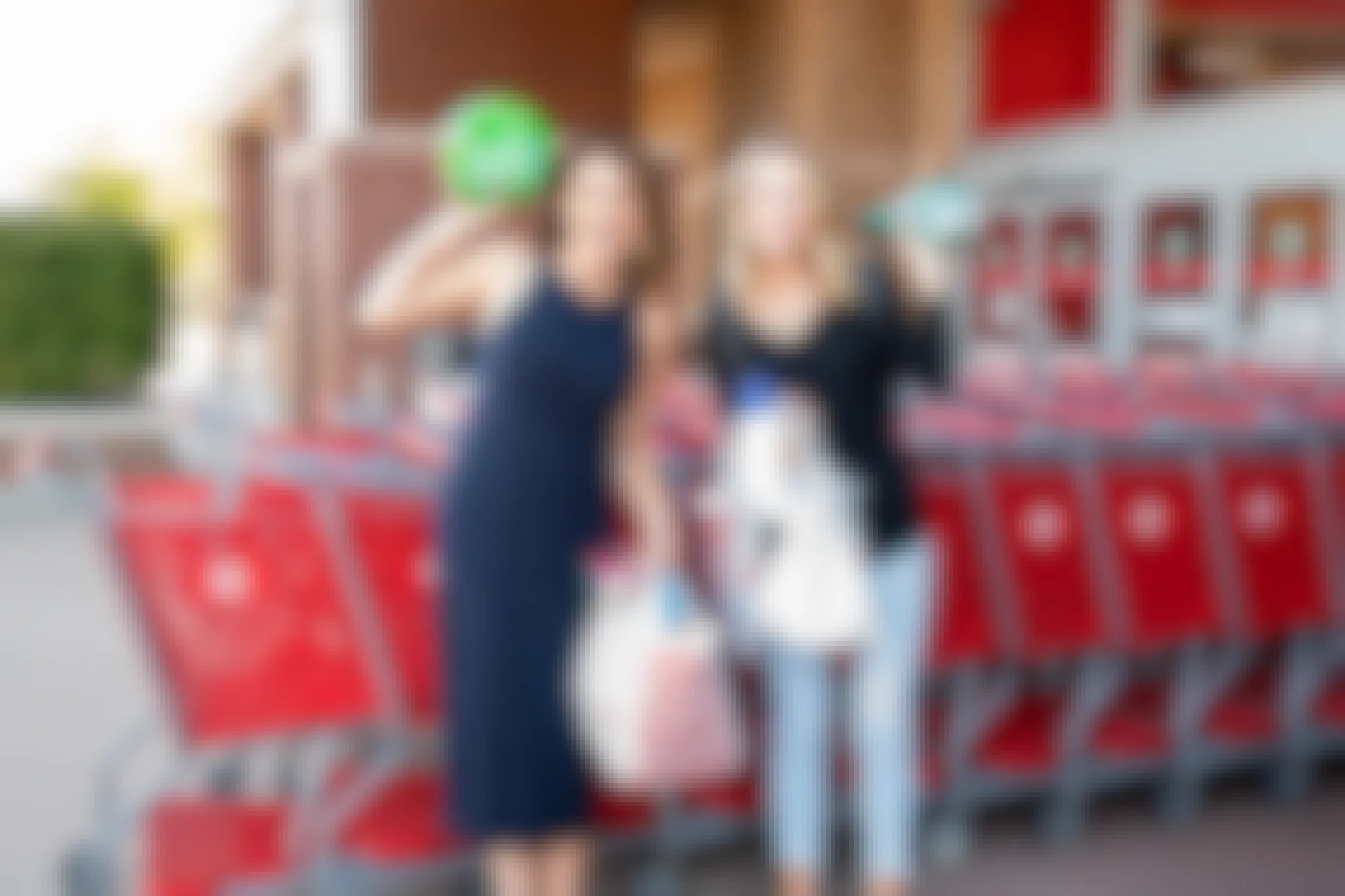 Two woman standing outside Target with shopping bags.