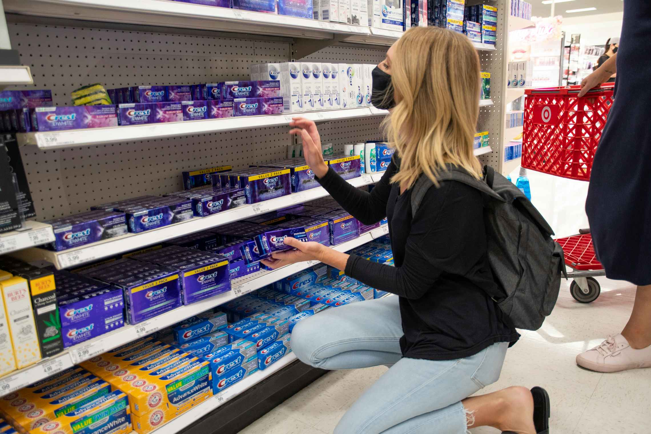 woman shopping for toothpaste