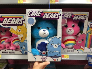 care bears grumpy bear held in front of more care bears