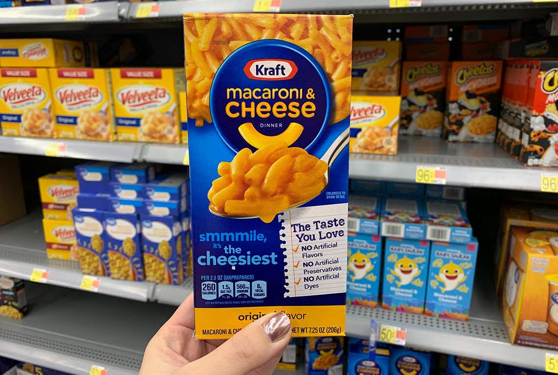 box of kraft mac & cheese held up in front of boxed pasta dinners