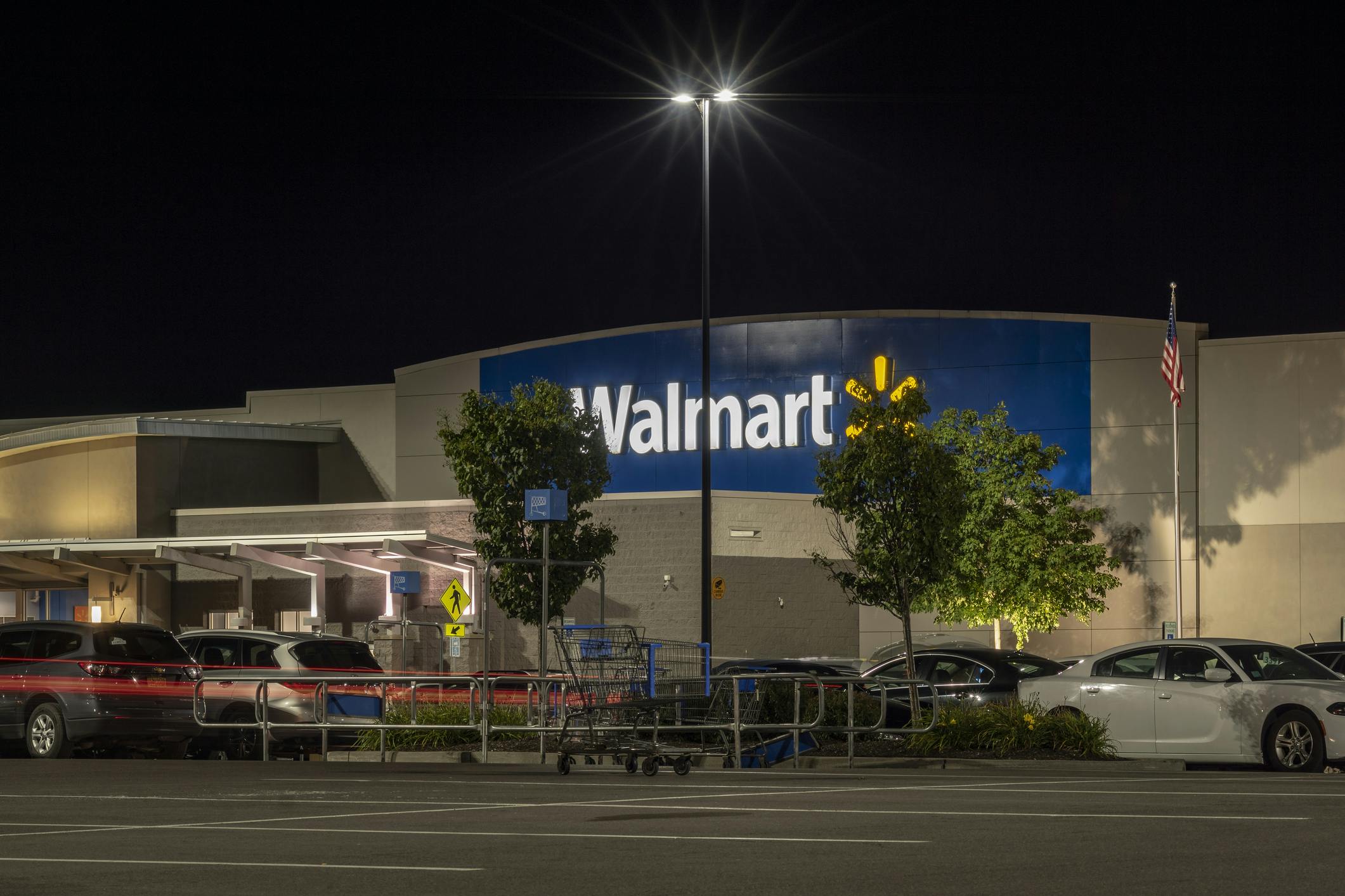 A Walmart storefront at nightime.