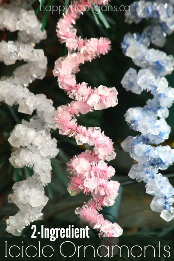 pink, blue and green crystals form on pipecleaners shaped in curlicues