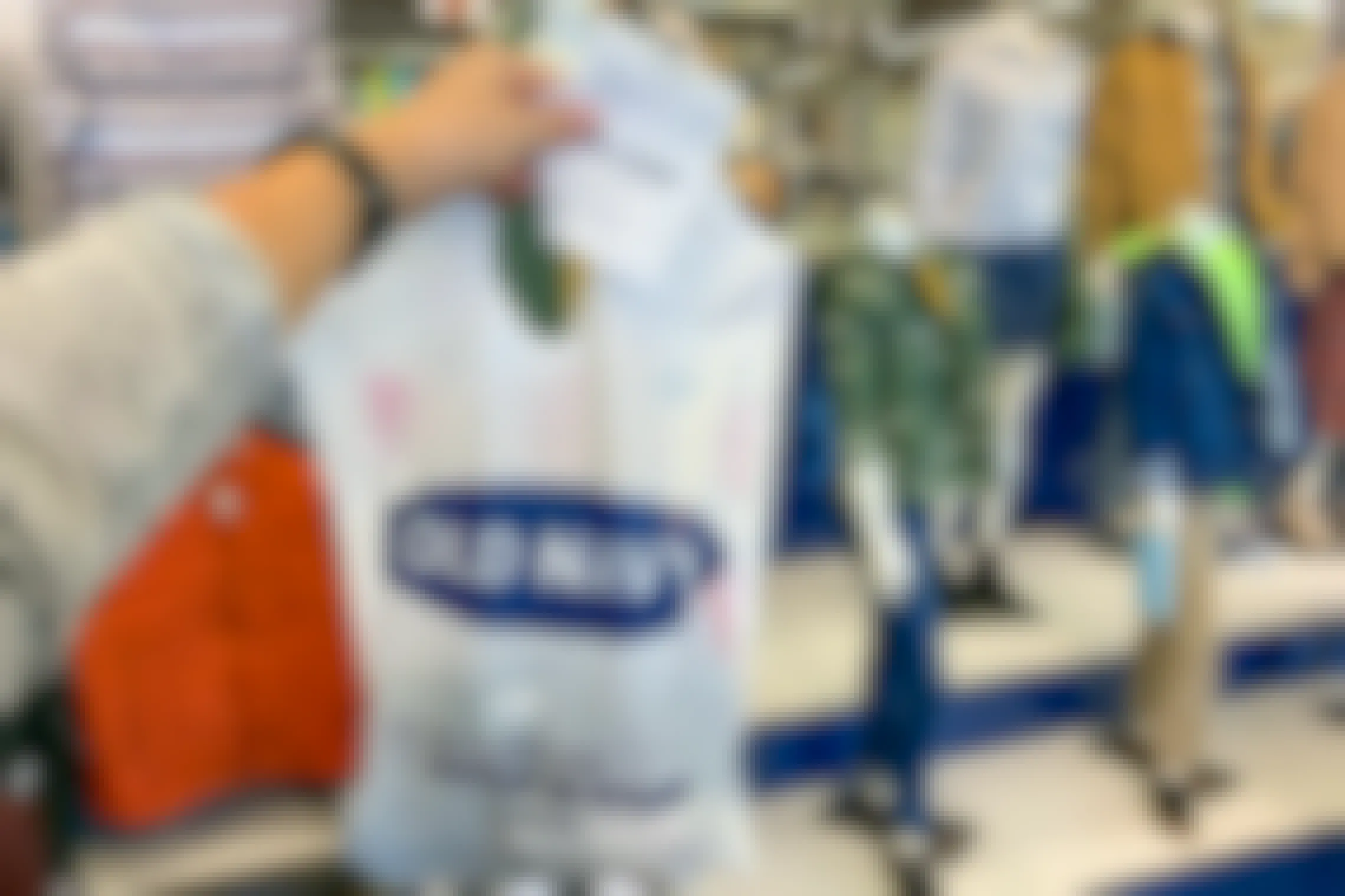 Gift receipt held in front of an old navy bag