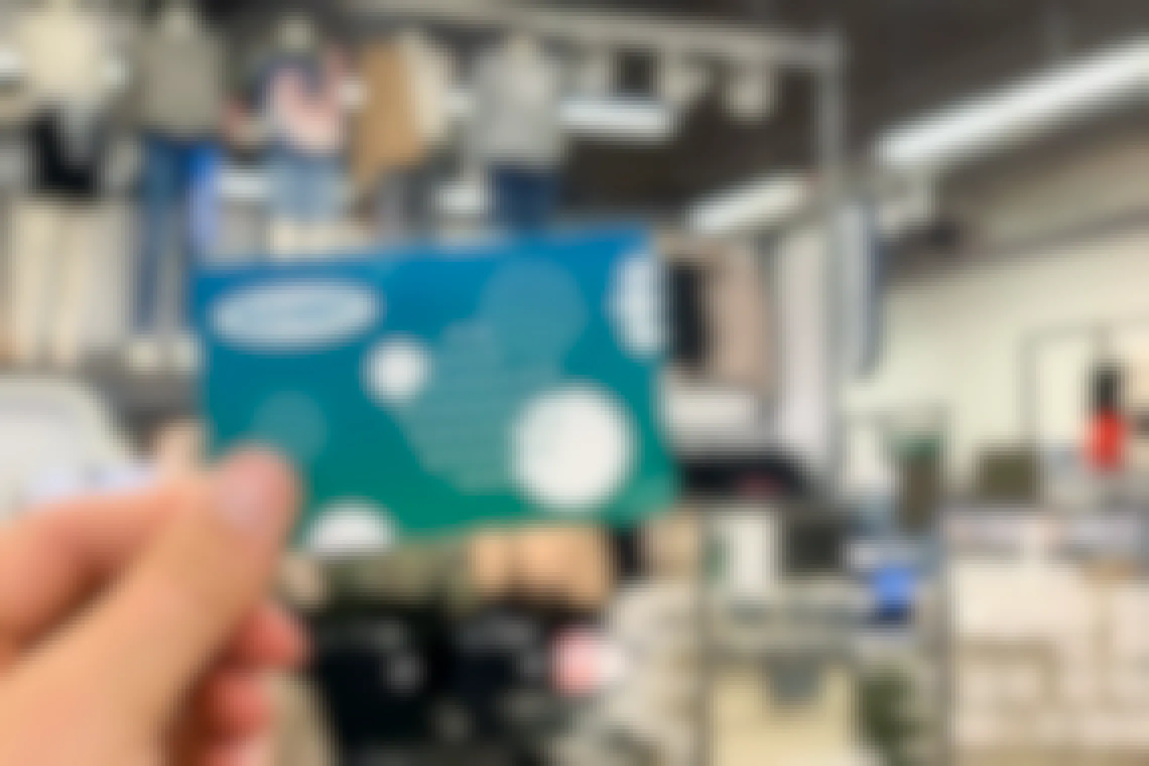 Old Navy gift card being held up in store with shirts in the background
