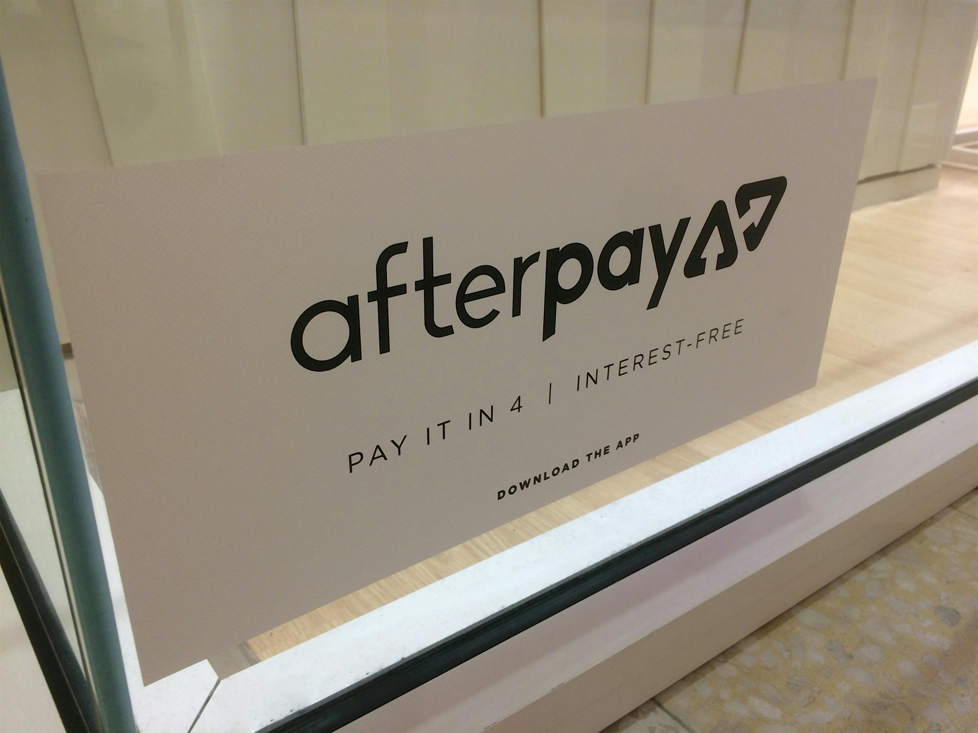 Sign for Afterpay buy now pay later service in a storefront window
