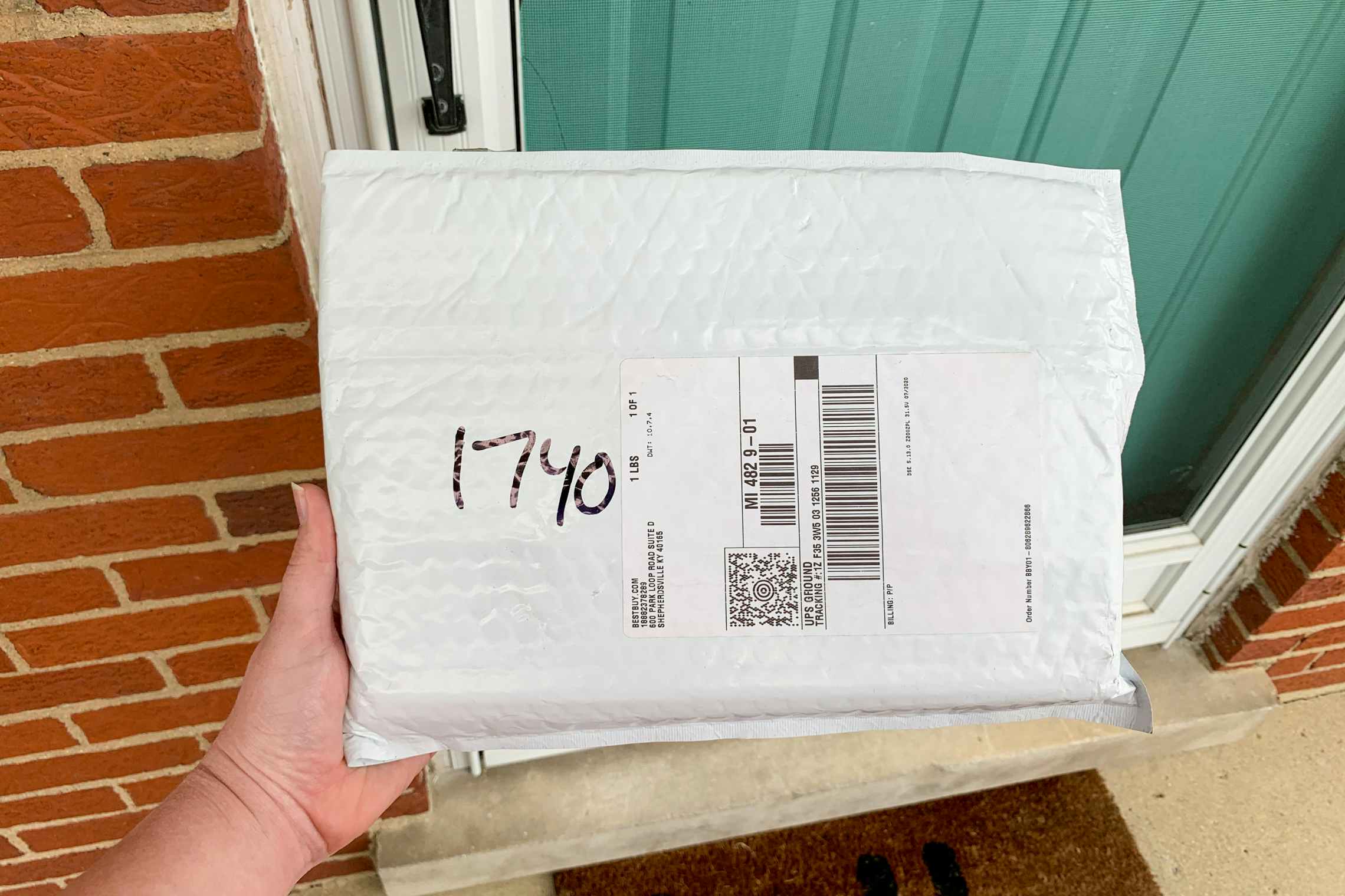 A best buy package at a front door.