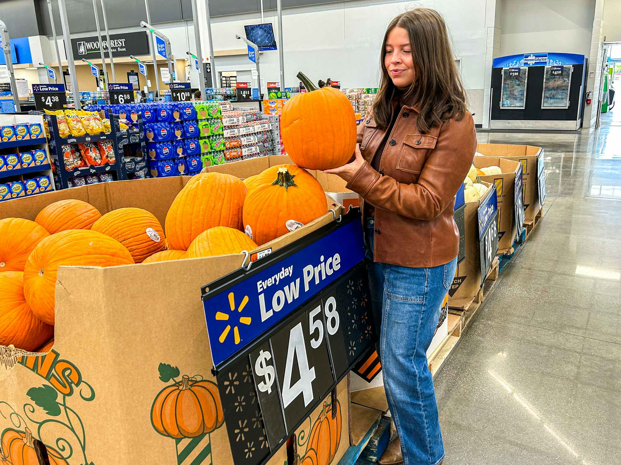 a person holding up a pumpkin at walmart