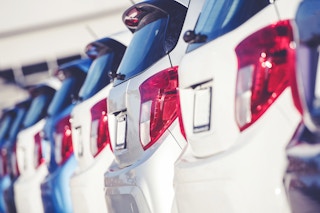 Car Dealer Business Concept. Row of Brand New Compact Cars on the Dealer Lot. Transportation Industry.