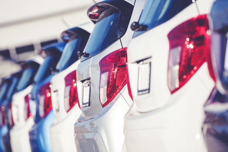 Car Dealer Business Concept. Row of Brand New Compact Cars on the Dealer Lot. Transportation Industry.