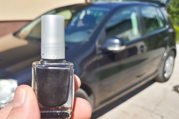 Black paint touch up for the car on car background. car paintwork repair