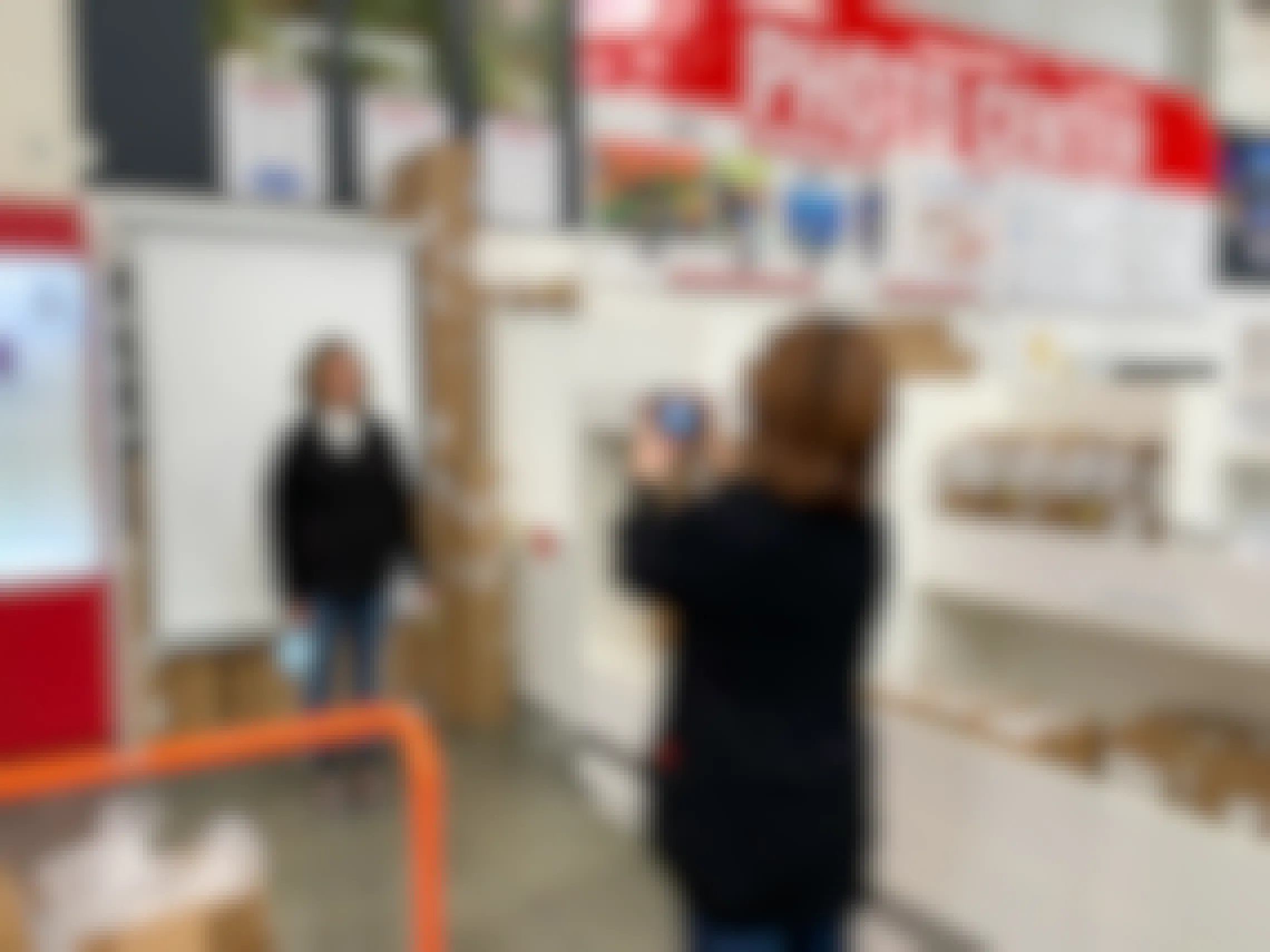 A woman getting a passport photo taken at the Costco Photo Center