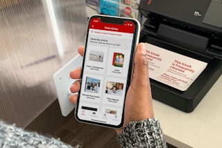 Woman holding cvs photo inside store