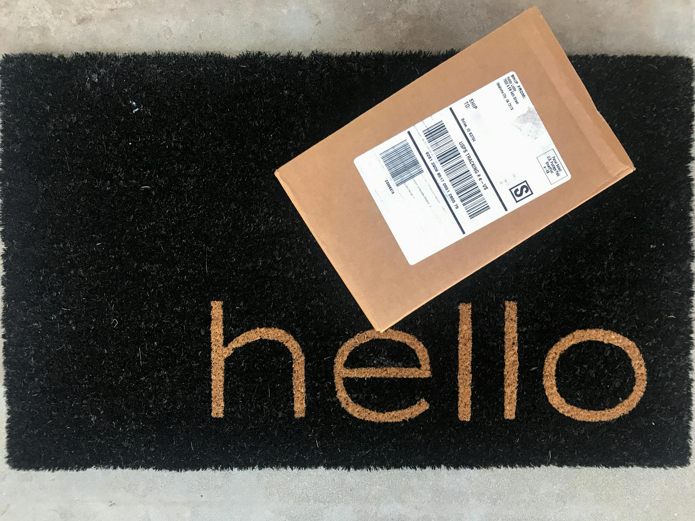 Hobby Lobby delivery box on black doorstep that say's "hello".
