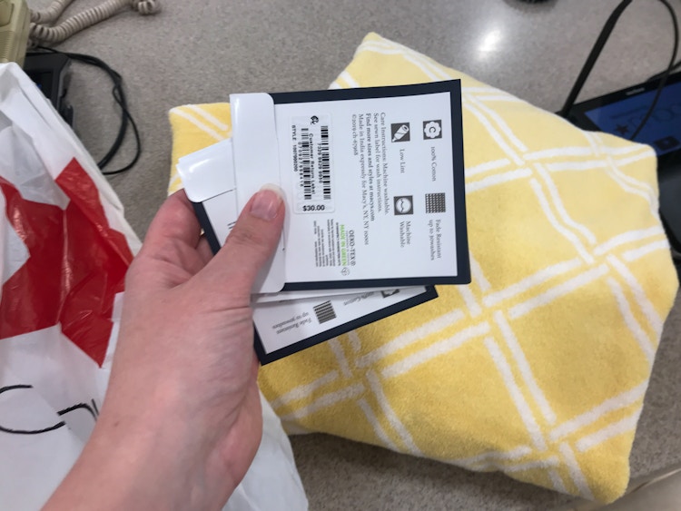 Yellow towels with product tags at the Macy's return counter