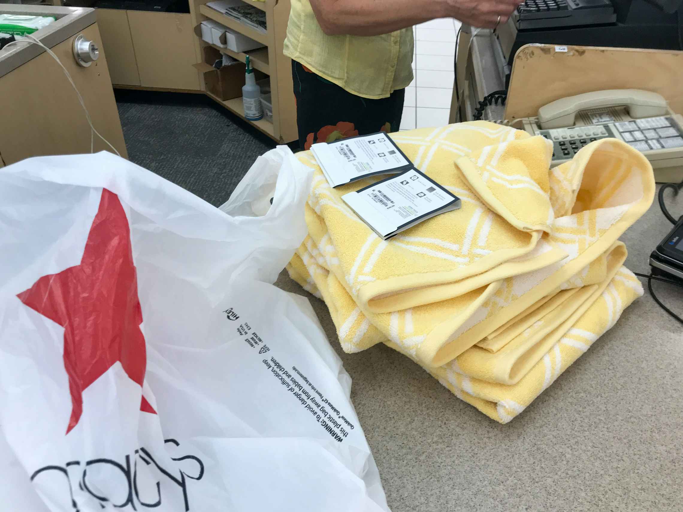 Yellow towels with product tags at the Macy's return counter
