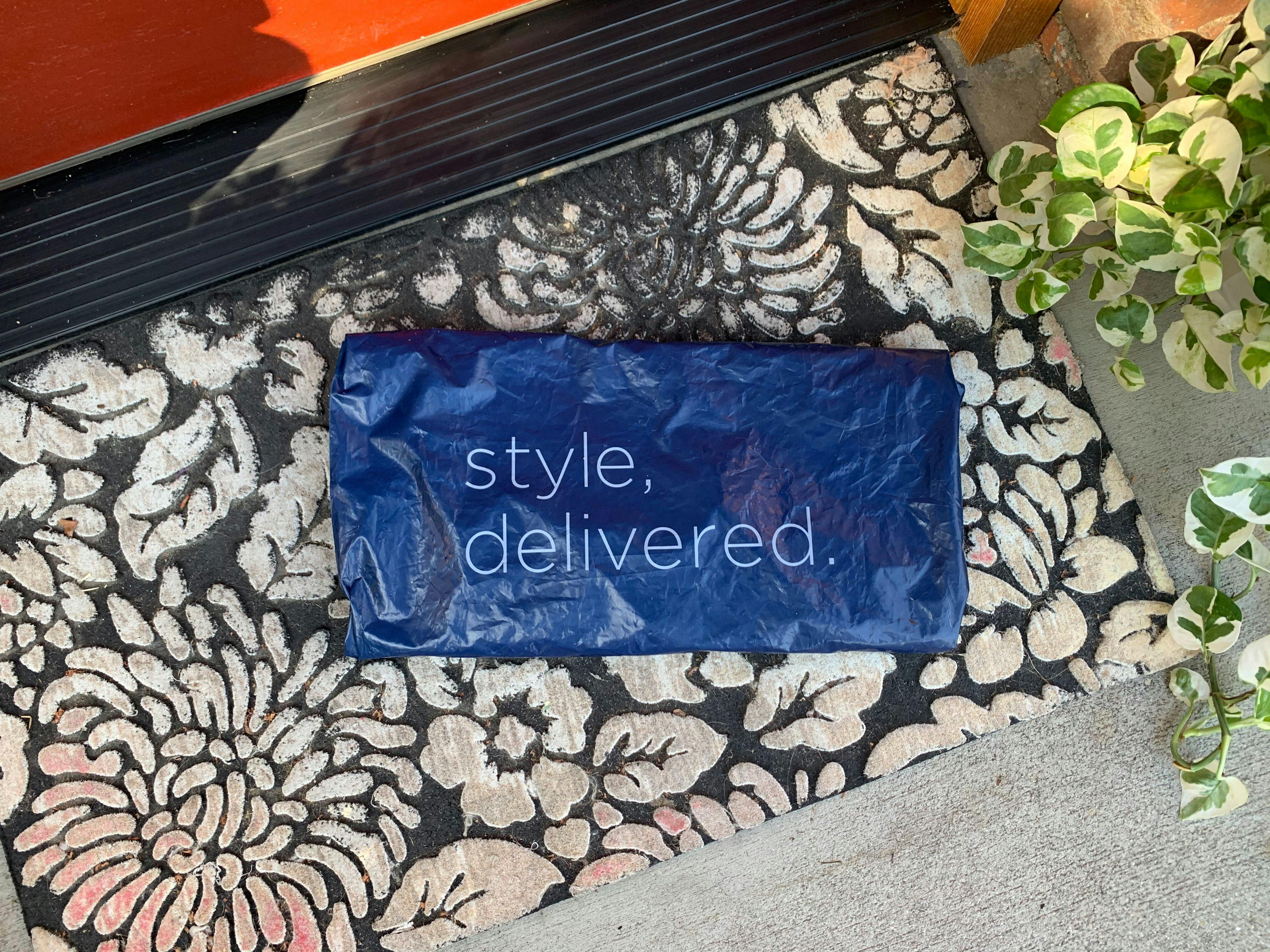 An Old Navy delivery package on the front porch of someone's house.
