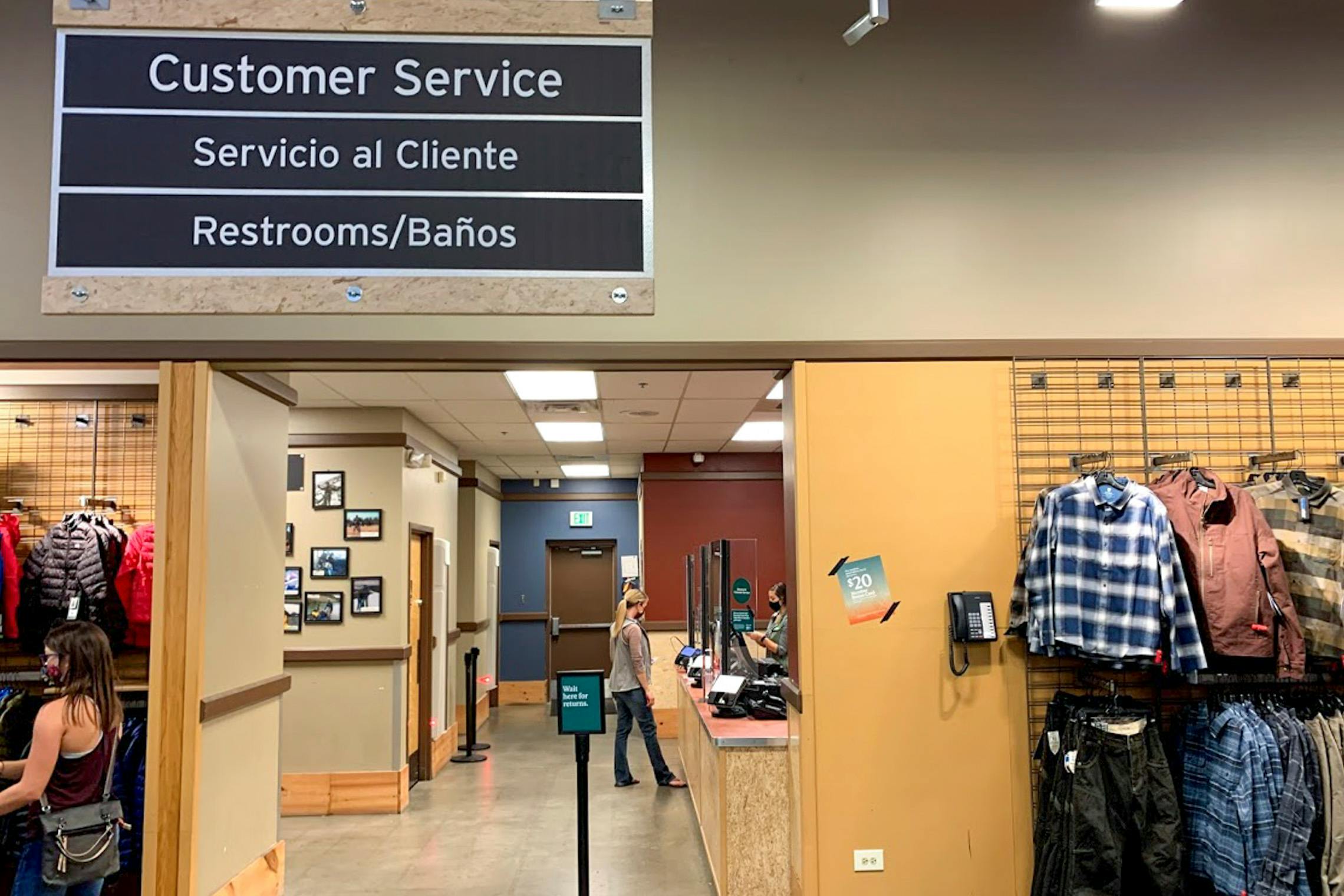 Customer service counter and sign inside REI