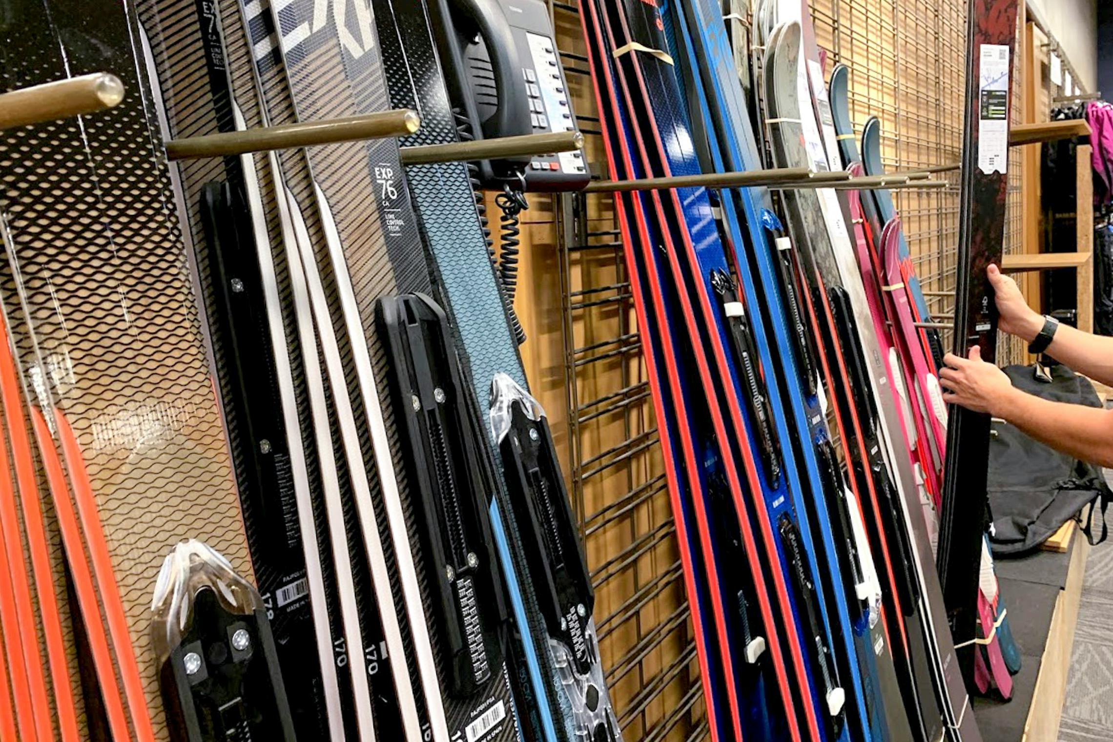 Man looking at skis in REI