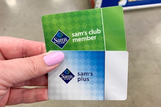 Two sams club membership cards held up in store