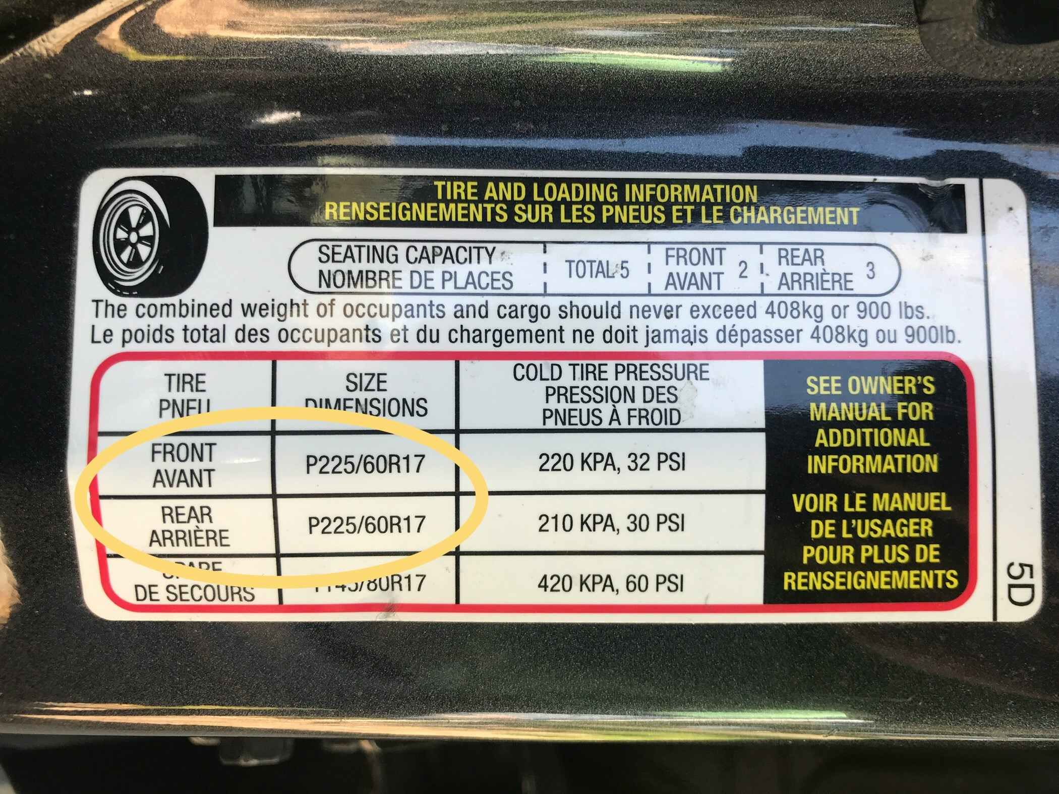 sticker on inside of car door shows tire size
