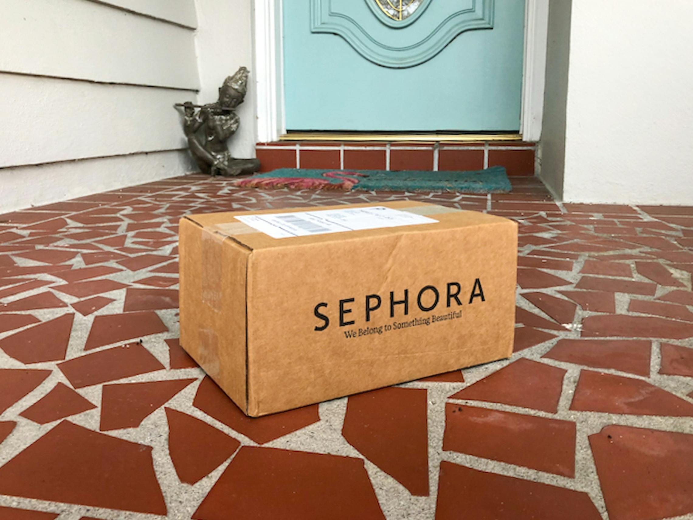 A Sephora box on a front doorstep.