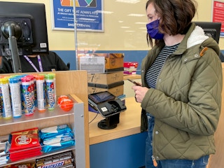 A customer purchasing items at the Shoe Carnival checkout