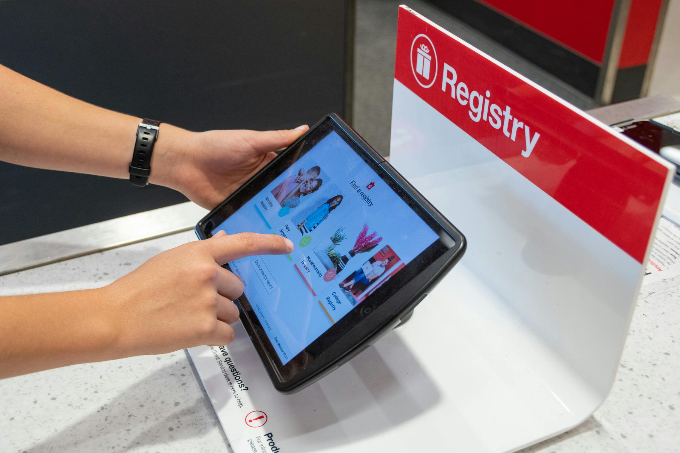 A person using the Registry tablet at the Target guest services desk.