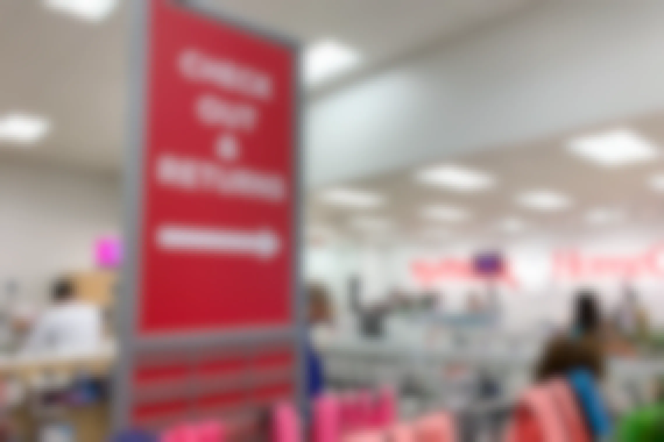 Check out and T.J.Maxx returns sign with people standing in line