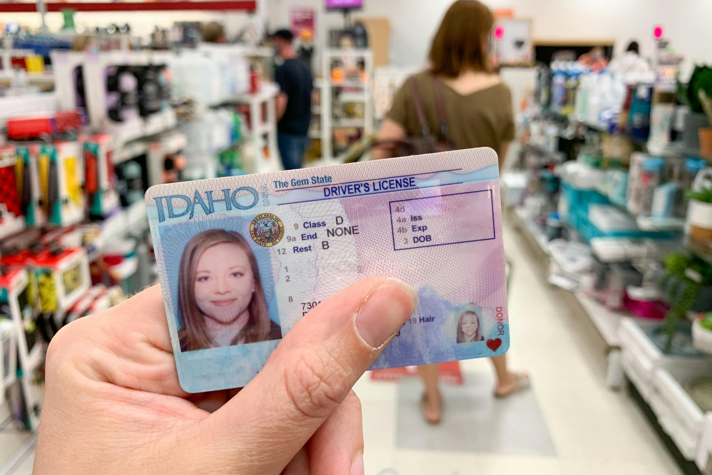 A person holding an ID in side TJ Maxx