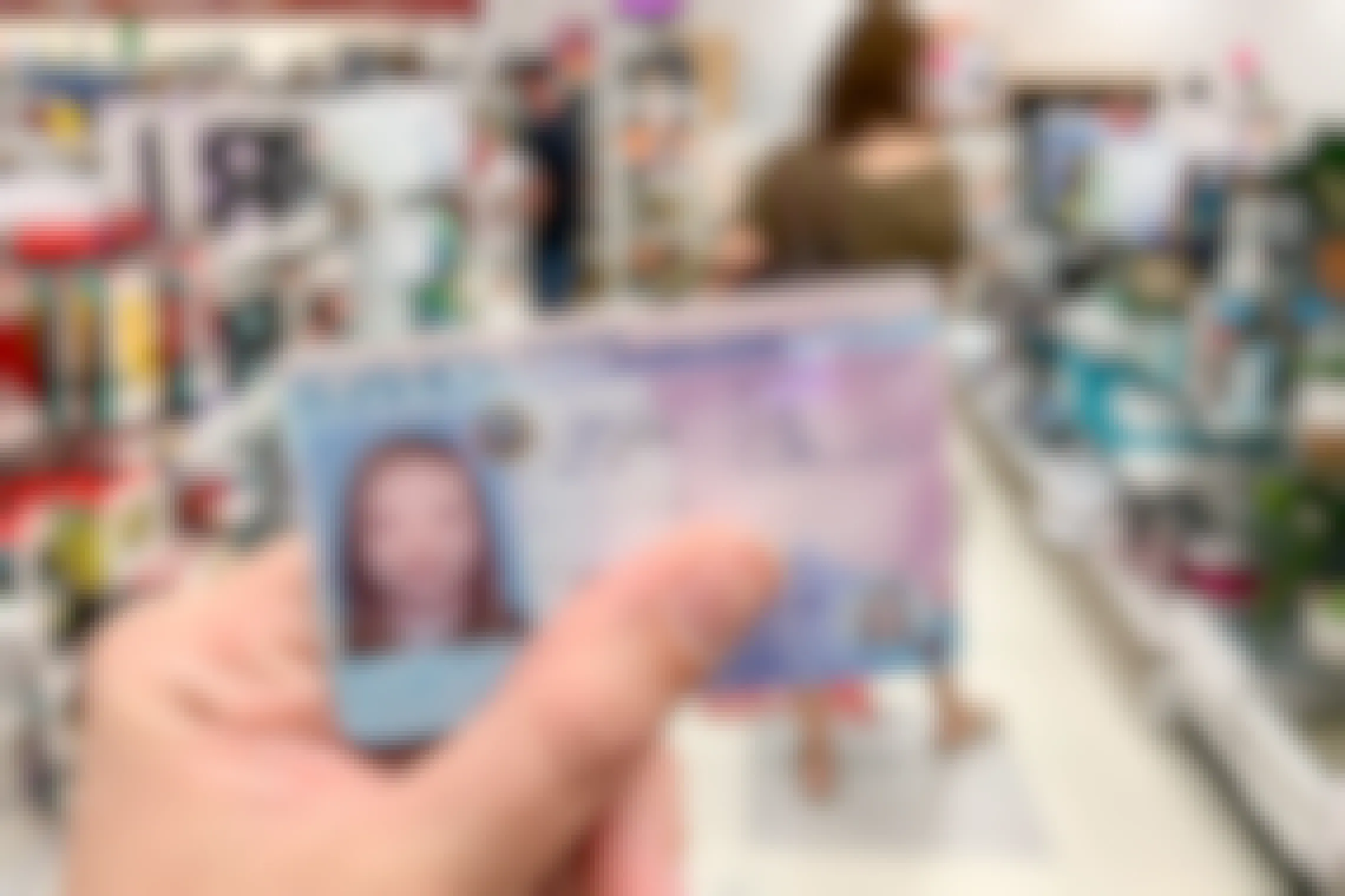 A person holding an ID in side TJ Maxx