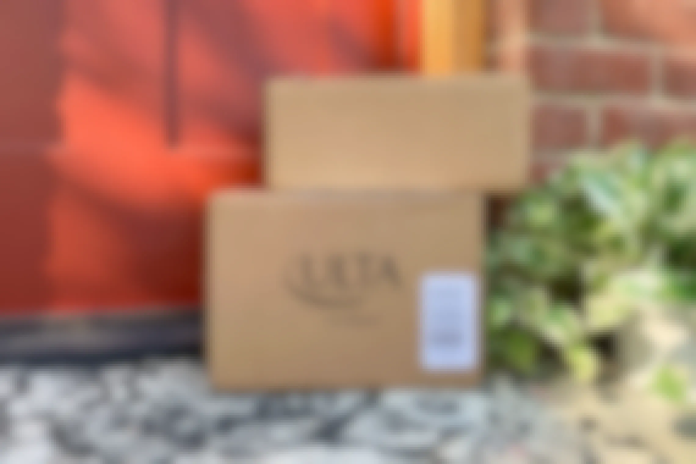 Ulta packages stacked on top of one another and sitting on someones front doorstep