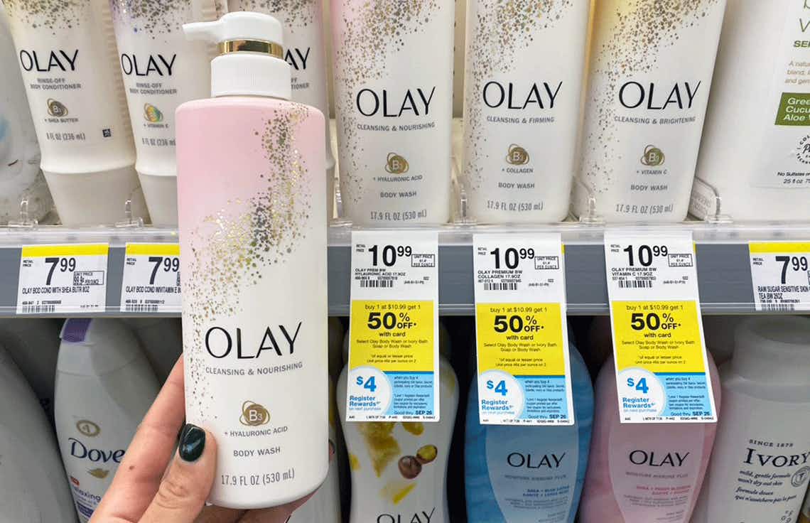 Woman holding a bottle of Olay body wash in a drugstore
