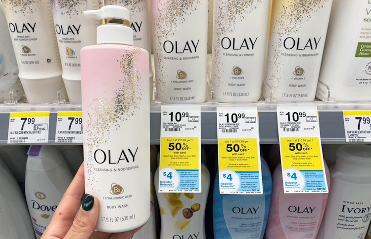 Woman holding a bottle of Olay body wash in a drugstore