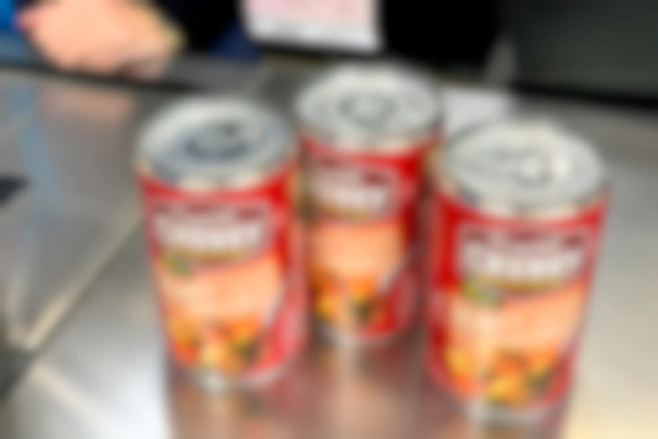 Three cans of chicken vegetable stew on the return counter at walmart