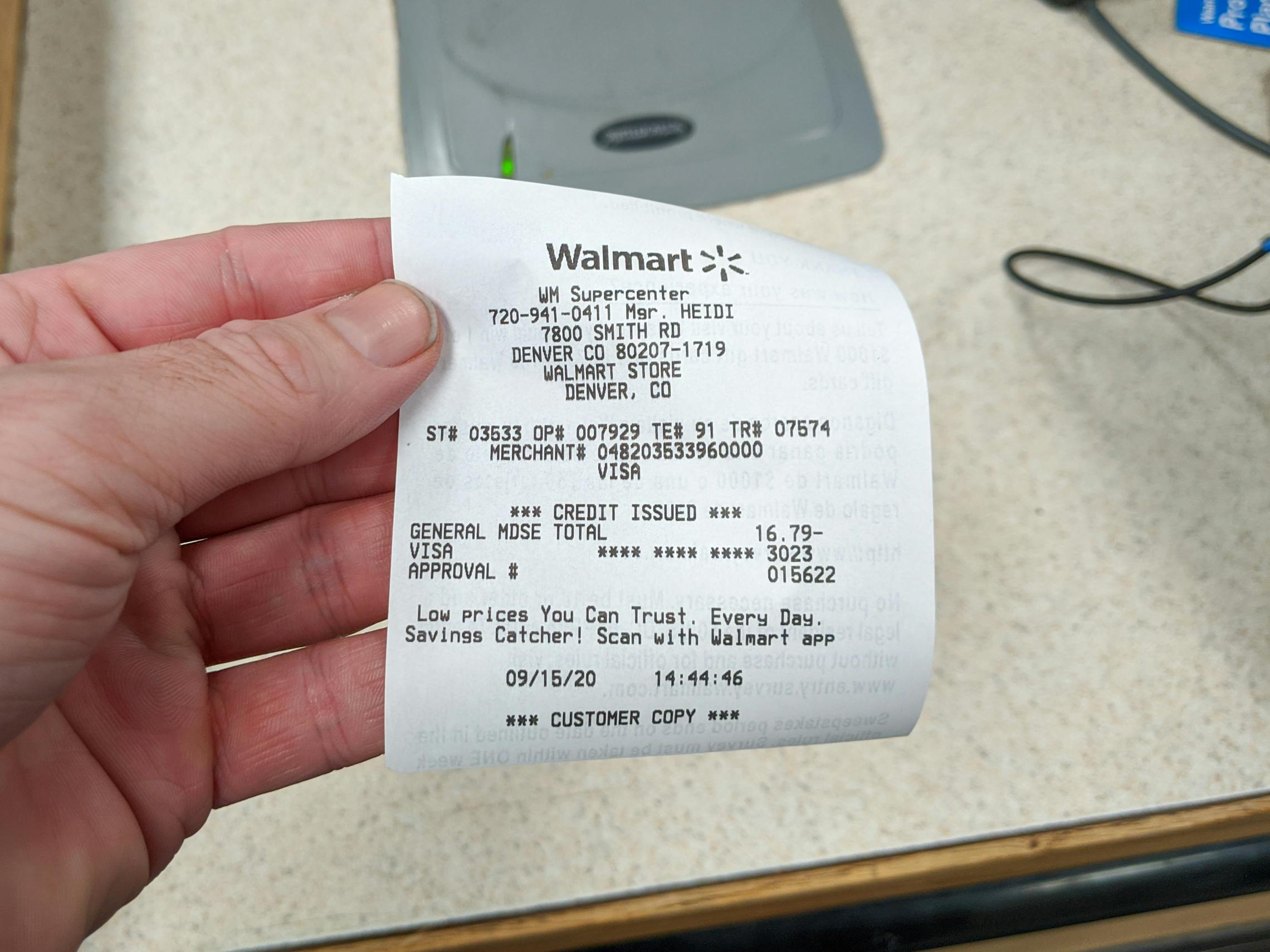 A person holding a Walmart return receipt