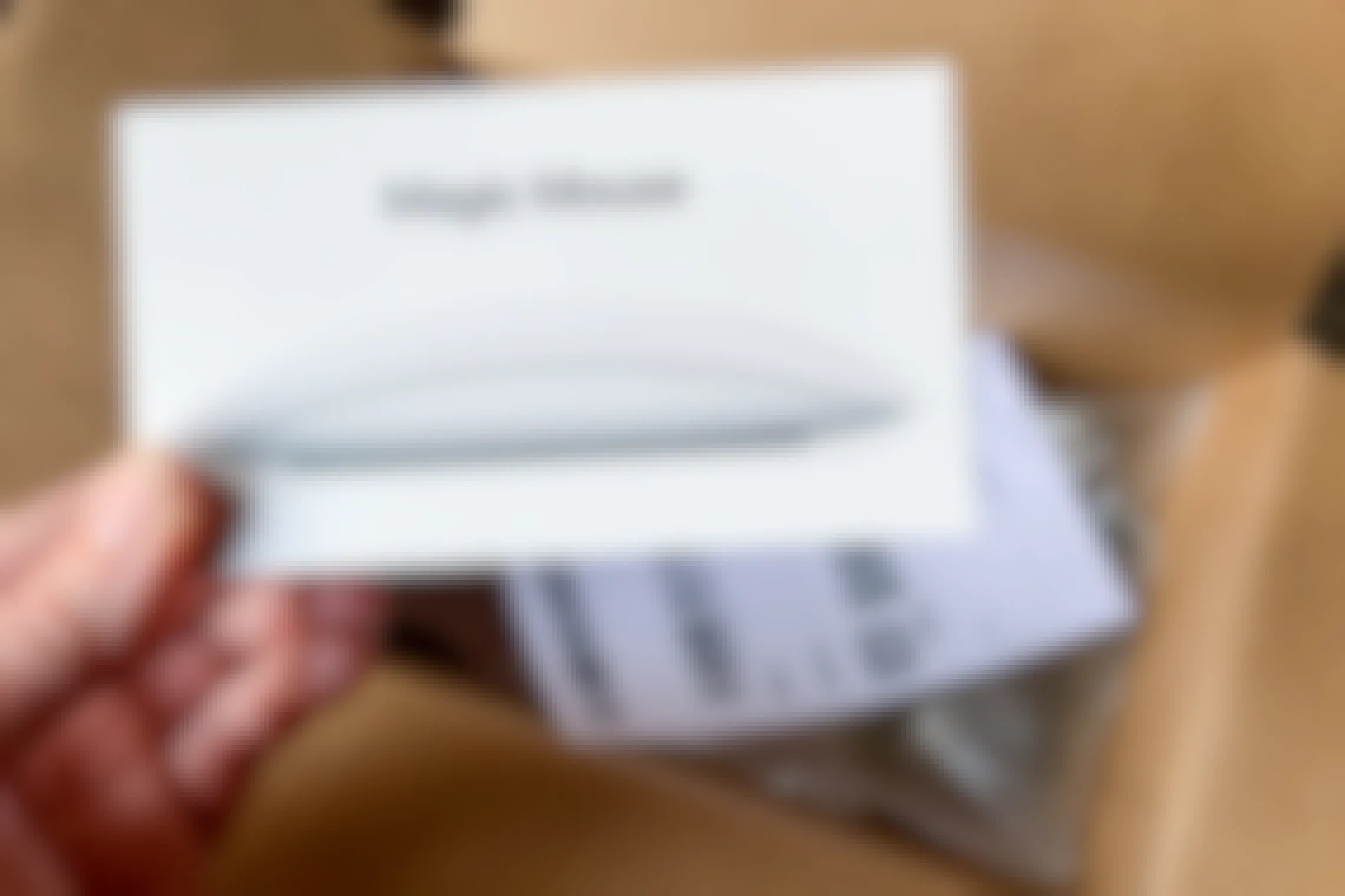 Apple magic mouse and return label next to a shipping box.