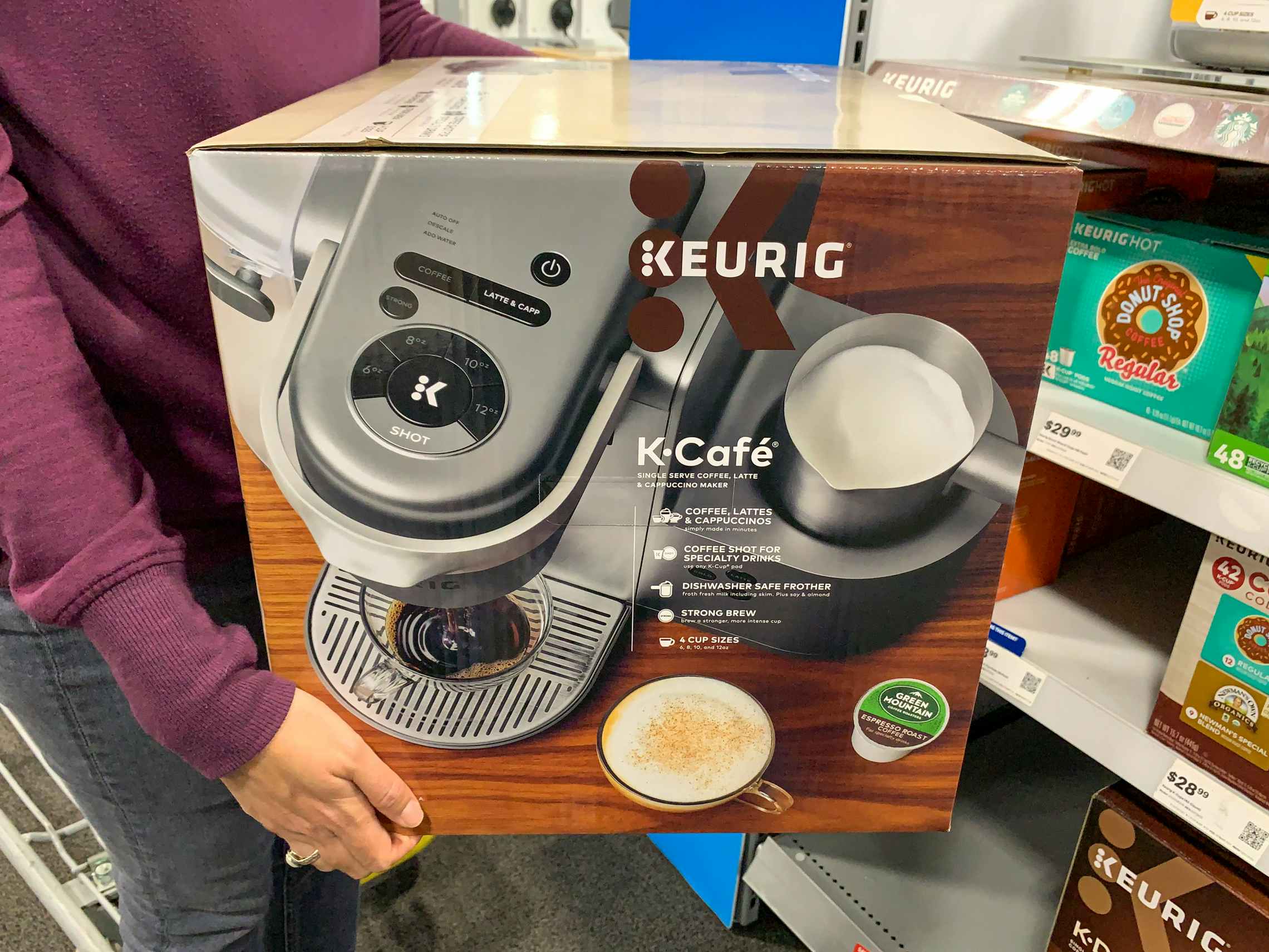 A woman holding Keurig coffee maker box at Best Buy