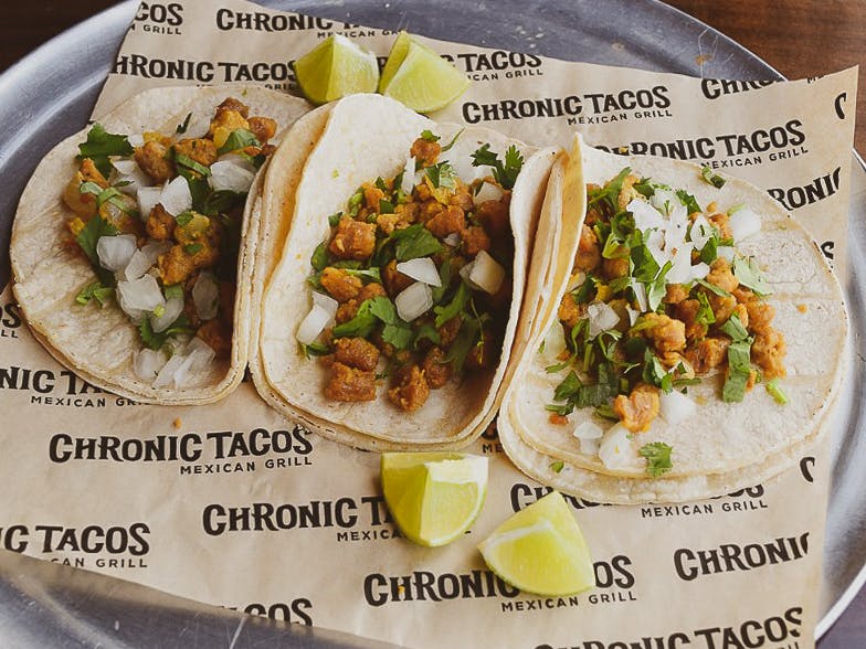 Three tacos from Chronic Tacos on a platter.
