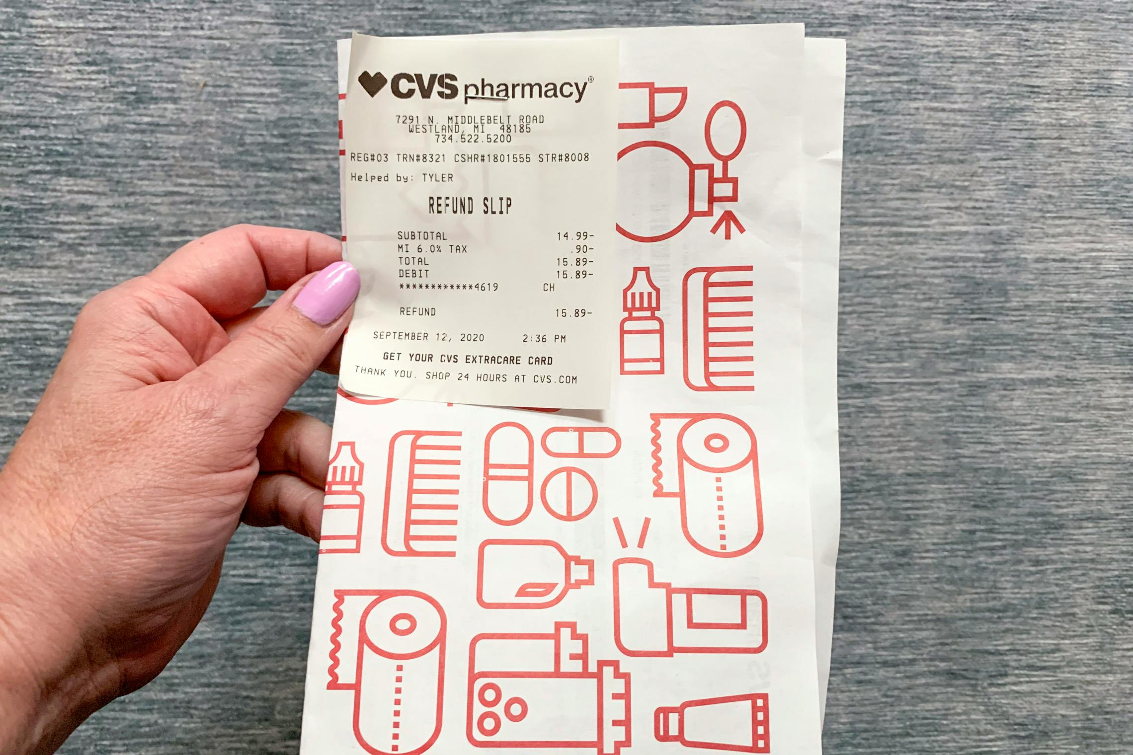Woman holding a refund slip from CVS