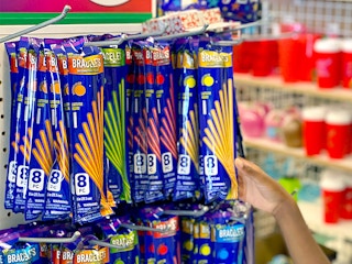 child grabbing glow stick bracelets from dollar tree end cap
