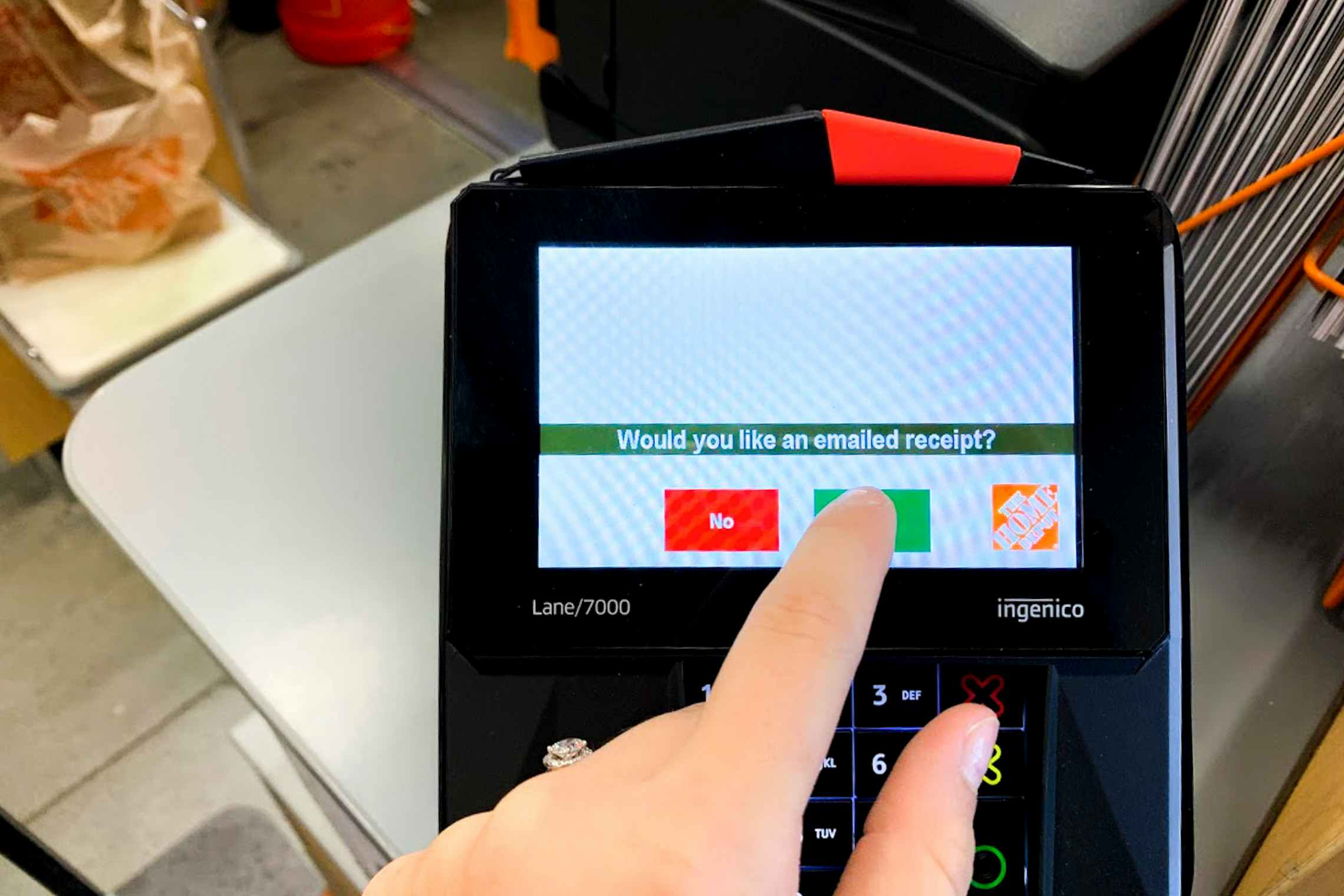 Someone checking yes to receiving an email receipt on a POS system at home depot